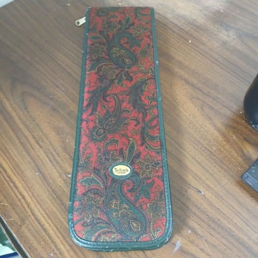 VTG Tie Rack London travel case features a red and gold paisley design zip close